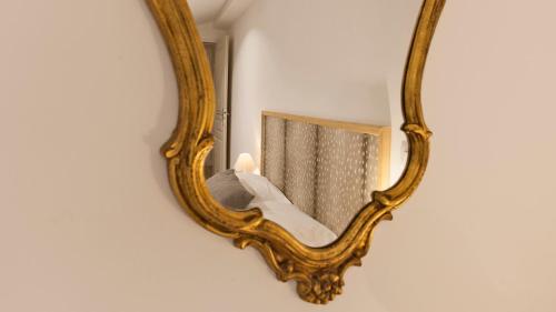 a mirror on a wall with a bed in it at Laniella location in Calvi