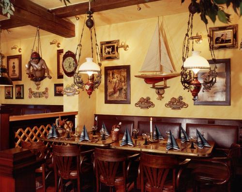 a dining room with a table with boats on it at Hotel & Restaurant Alter Speicher in Greifswald
