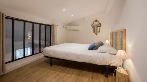 a bedroom with a bed and a large window at Laniella location in Calvi