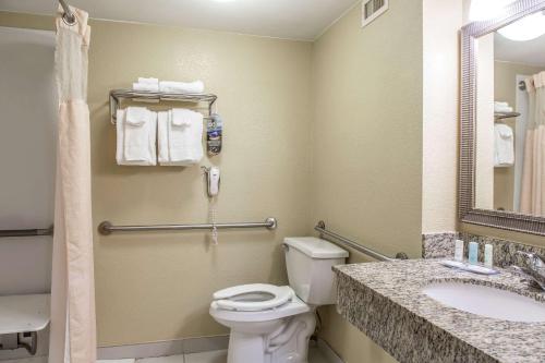 a bathroom with a toilet and a sink at Clarion Inn New London - Mystic in New London