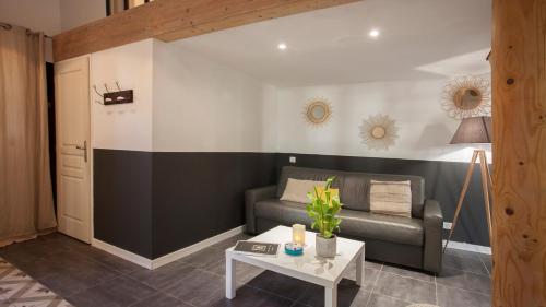 a living room with a couch and a table at Laniella location in Calvi