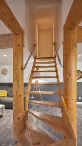 a wooden bunk bed with a ladder in a room at Laniella location in Calvi