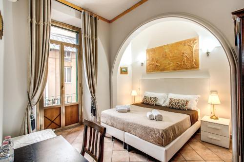 a bedroom with a bed and an arched doorway at Beautiful Home in Rome