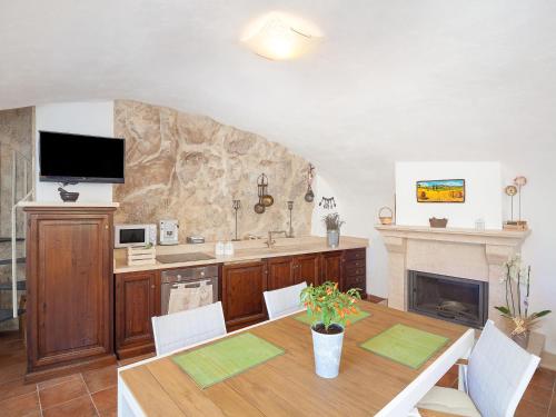 a dining room with a table and a fireplace at La Casa Sul Lago in Posta Fibreno