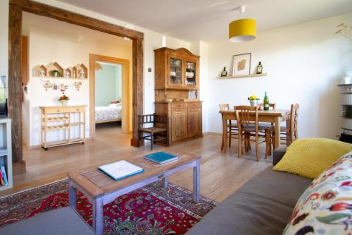 a living room with a couch and a table at Le Gîte du Moulin in Ribeauvillé