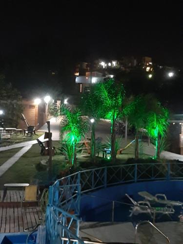 a view of a park at night with green lights at Complejo Los Cipreses in Villa Carlos Paz
