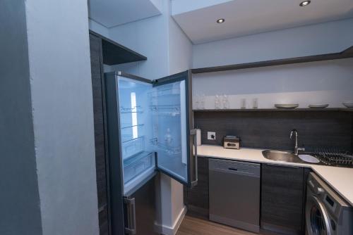a kitchen with a refrigerator and a sink at Six One Five at Matrix in Cape Town