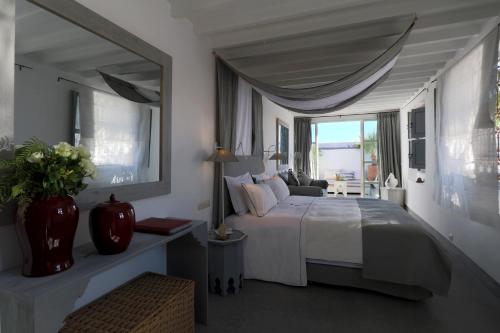 a bedroom with a large bed and a vase of flowers at Dar Seven in Marrakesh