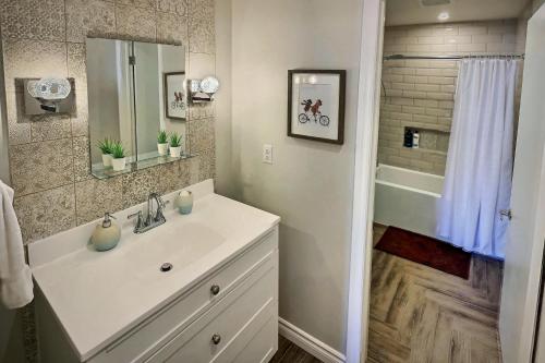 a white bathroom with a sink and a shower at Gite du Survenant Montreal in Montréal