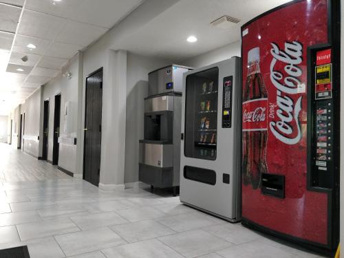 a cocacola vending machine in a hallway of a building at SureStay Hotel by Best Western Orange in Orange