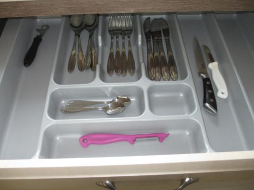 a white tray with utensils in a drawer at Apartmány U Procházků in Český Krumlov