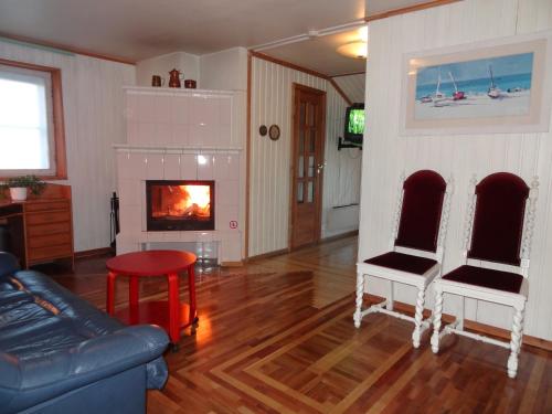 a living room with a couch and a fireplace at White Villa in Tallinn