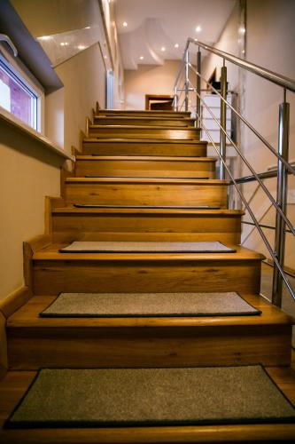 a set of wooden stairs with a rug on them at NORDIC Home in Deva