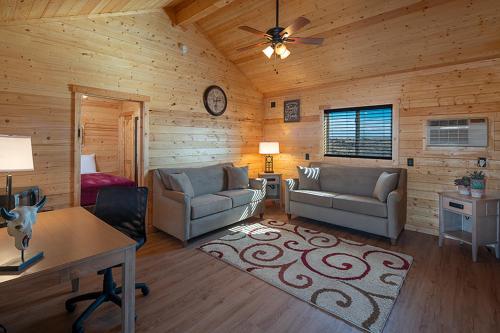 a living room with two couches and a table at Cabins at Grand Canyon West in Peach Springs