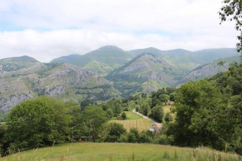 a view of a mountain range with a road at Los Pradones in San Roque de Ríomiera
