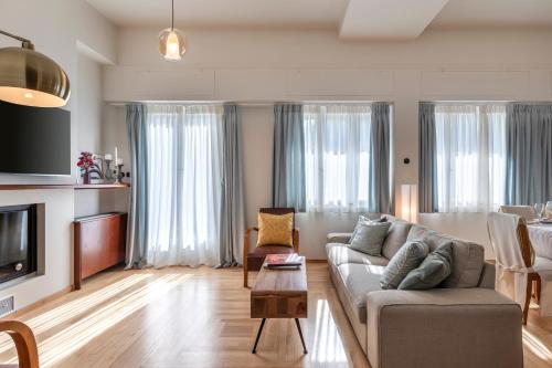 a living room with a couch and a table at Villa Razi 1935 in Loutraki