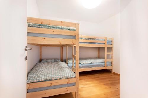 a couple of bunk beds in a room at Alpine Home Apartment in Bohinj