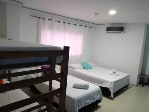 a bedroom with two bunk beds and a window at Aptos Majos centro in San Andrés