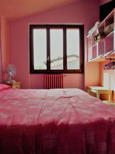a bedroom with a large bed and a window at Albergo Ristorante La Rocca in Firenzuola