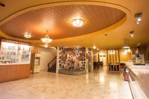 a lobby with a fireplace in the middle of a building at Gene Long Haiy Att Hotel in Chiayi City