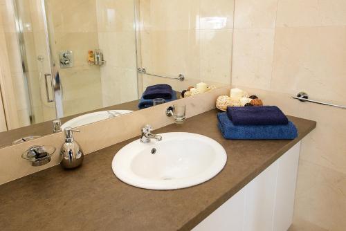 a bathroom counter with a sink and a mirror at Chopok juh Apartman Vanda in Tale