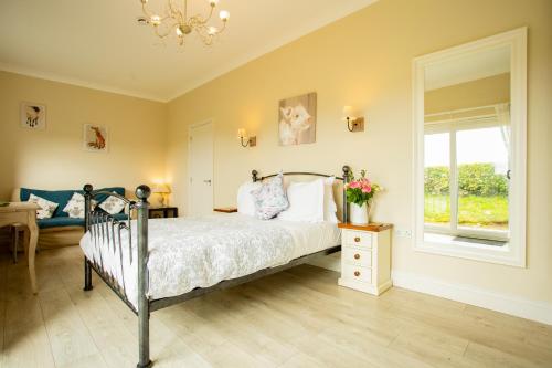 a bedroom with a bed and a window and a chandelier at Accommodation Bristol Airport in Redhill