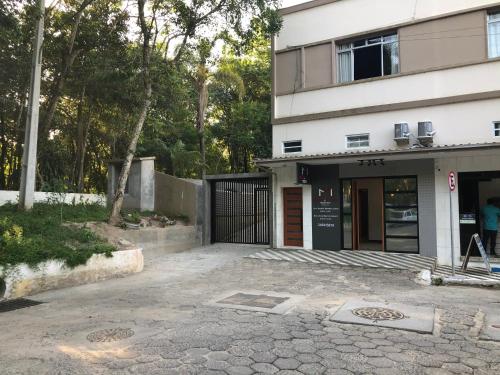 a building with a gate in front of it at Chalés no meu quintal in Louro Müller