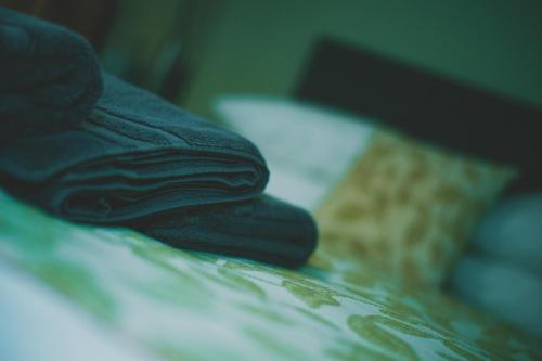 a black towel sitting on top of a bed at The Kings Head in New Buckenham