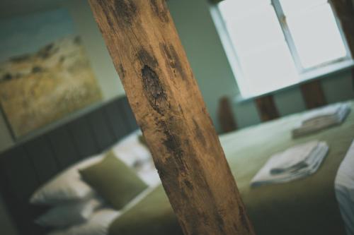 a wooden pole in front of a bed at The Kings Head in New Buckenham