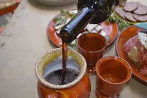 a person is pouring coffee into a cup on a table at Casa D'armaros in Kissamos