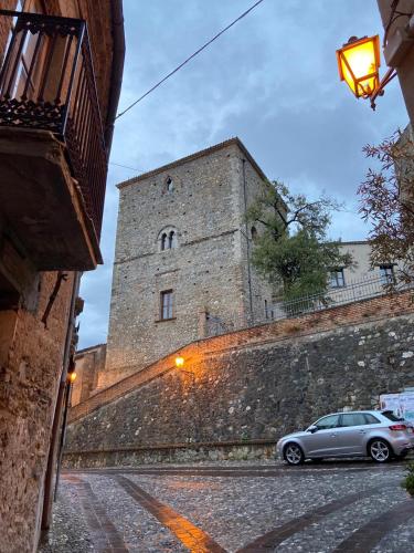 a car parked in front of a large castle at B&B L'Antica Balbia in Altomonte