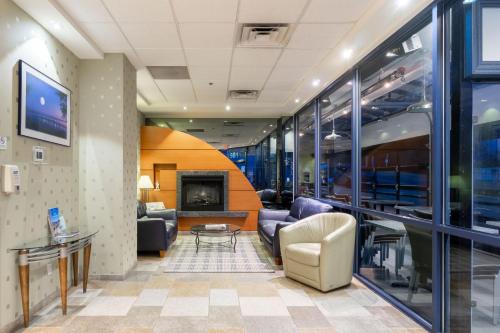 a waiting room with couches and a fireplace at Ocean Promenade Hotel in White Rock