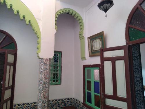 a room with two arches and two doors at My house in Rabat