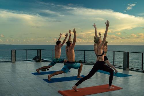 a group of people doing yoga on a cruise ship at Hush Maderas in San Juan del Sur