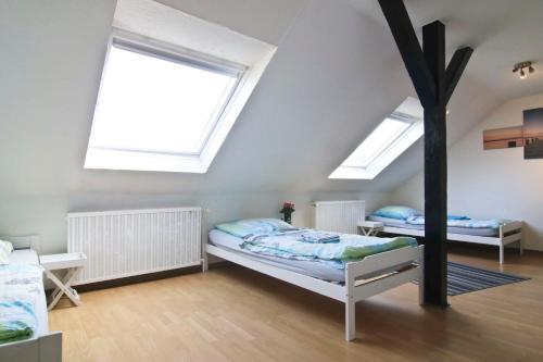 a bedroom with two beds and two skylights at apartmondo Apartmentwohnungen Remscheid in Remscheid