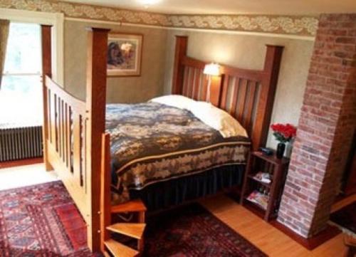 a bedroom with a bed and a staircase in a room at Alaska's Capital Inn Bed and Breakfast in Juneau