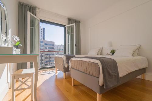 a bedroom with a bed and a large window at Lisbon Best Places - Rooftop in Lisbon