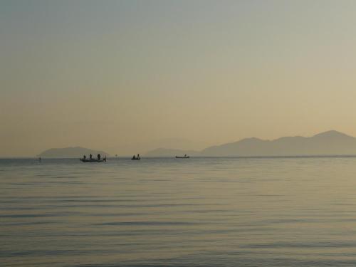 a group of people in boats on the water at Youth Hostel WANIHAMA-Beach side Lake BIWA in Otsu