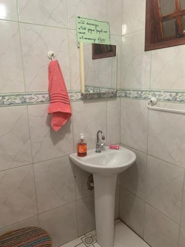 a bathroom with a sink and a mirror at Casa do Cais in Abraão