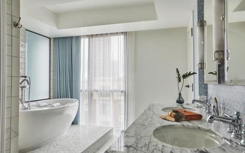 a bathroom with a tub and a sink at Pendry San Diego in San Diego