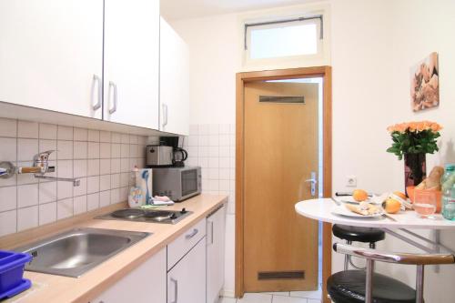 a kitchen with a sink and a counter top at apartmondo Apartmentwohnungen Remscheid in Remscheid