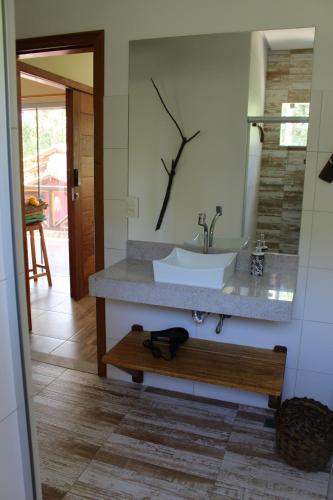 a bathroom with a sink and a mirror at PachaMama Flats - Taipu de Fora in Barra Grande