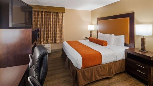 a hotel room with a large bed and a television at Best Western Crossroads of the Bluffs in Council Bluffs