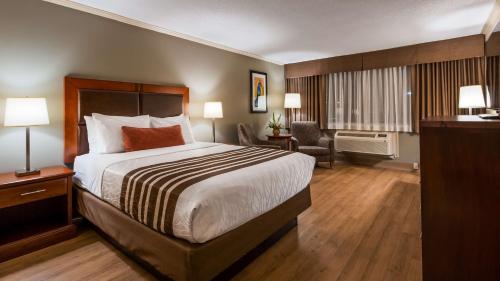 a hotel room with a large bed and a desk at Best Western Plus Ottawa City Centre in Ottawa