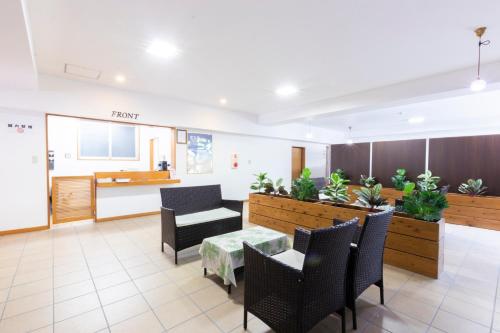 a waiting room with a table and chairs at Y' RISE TO HOTEL Miyakojima in Miyako Island