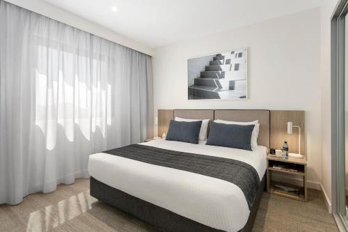 
A bed or beds in a room at Quest Joondalup
