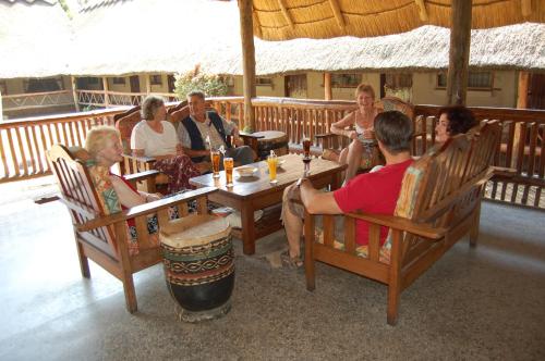 a group of people sitting at a table in a restaurant at Ravine Lodge in Livingstone