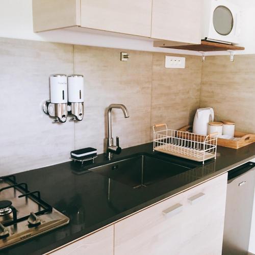 a kitchen with a sink and a counter top at Fare noanoa in Mariuti