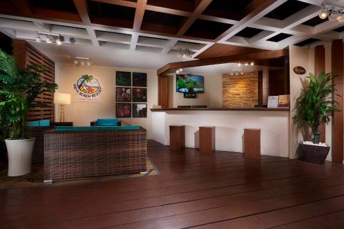 a kitchen with a wooden floor and wooden cabinets at Paya Beach Spa & Dive Resort in Tioman Island
