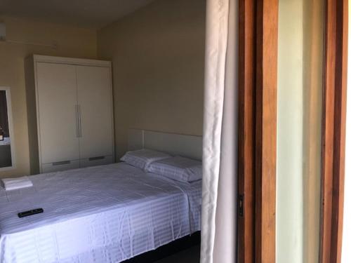 a bedroom with a bed and a cupboard at Chalés Polinésia in Touros